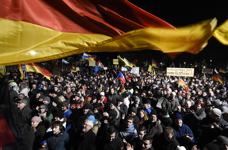 FILE - In this Monday, Jan. 12, 2015 file photo, demonstrators bear flags of several European countries during a rally of the group Patriotic Europeans against the Islamization of the West, or PEGIDA, in Dresden, Germany. Firebombs and pigs' heads are being tossed at mosques and women in veils have been insulted in a surge of anti-Muslim acts since last week's murderous assault on the newsroom of a satirical Paris paper, according to a Muslim who tracks such incidents in France. France's large Muslim population risks becoming collateral damage in the aftermath of the three attacks by French radical Islamists who killed 17 people. Muslims in other European countries also won't be spared, some Muslim leaders and experts say. Concern about a backlash against Muslims was discussed Monday Jan. 13, 2015, during a meeting on counter-terrorism measures at the Interior Ministry. (AP Photo/Jens Meyer, File)